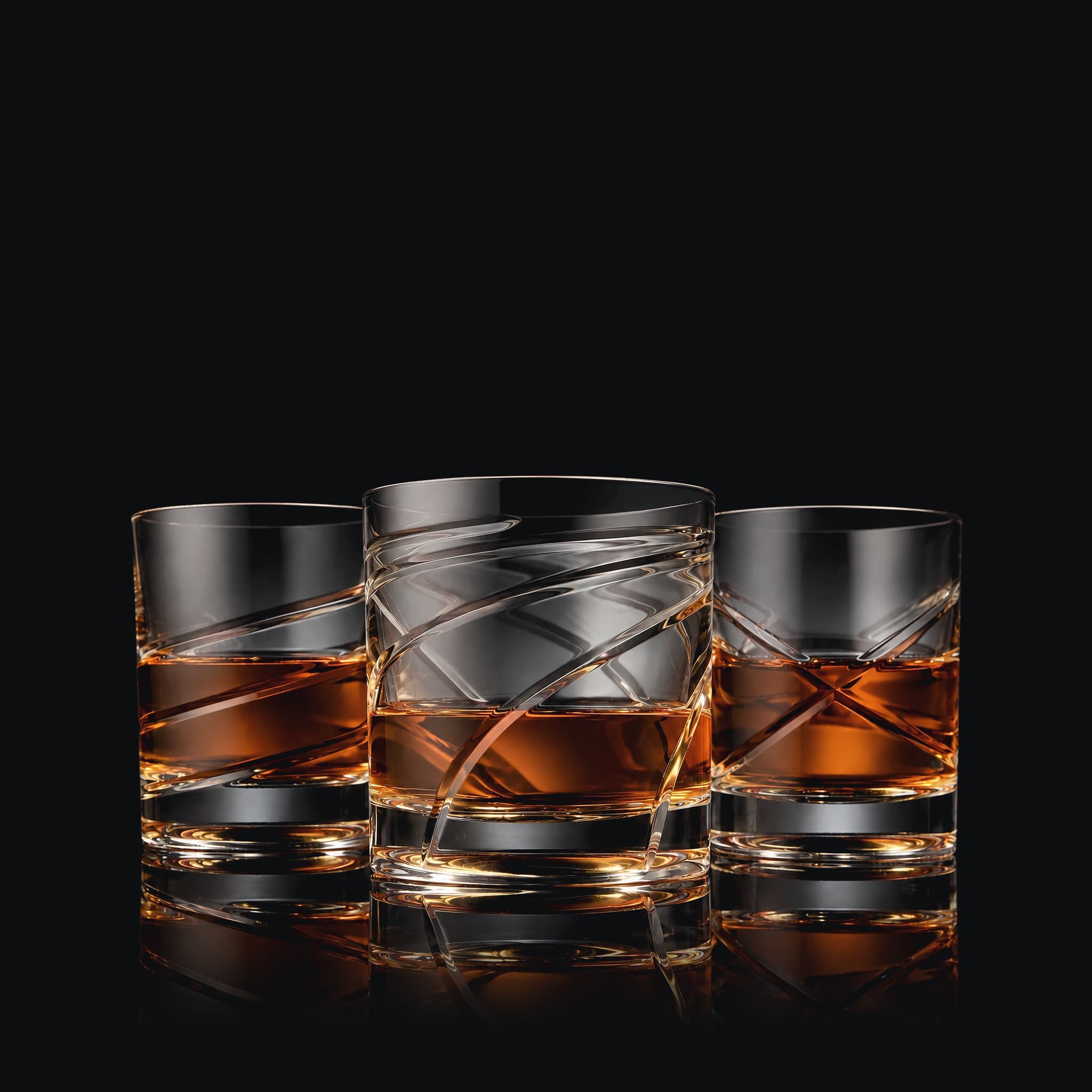 The SHTOX Rings set: Tempest, Twilight and Crosswind tumblers with whisky, on black