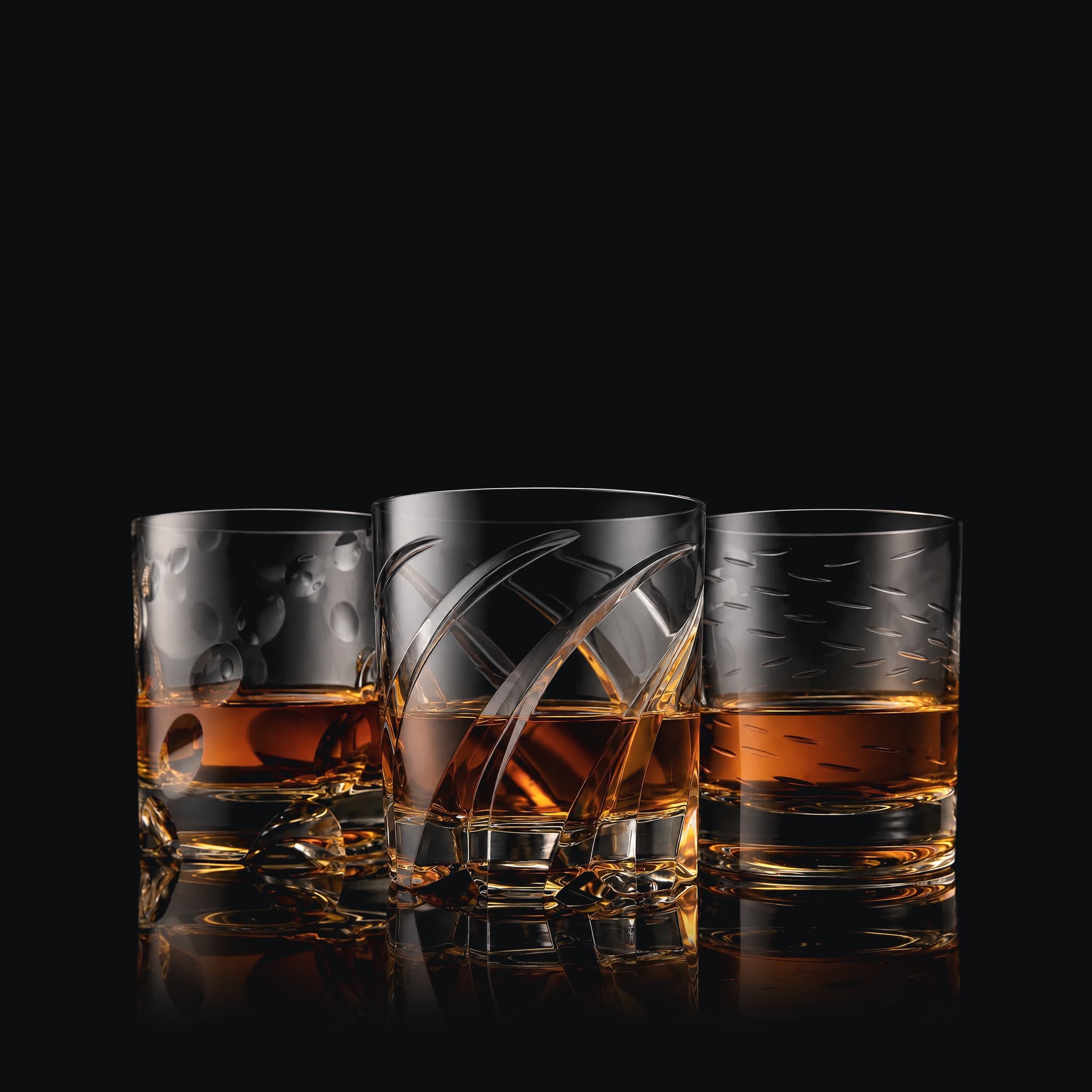 The SHTOX Special set: Rain, Edgewave and Lumen tumblers with whisky, on black