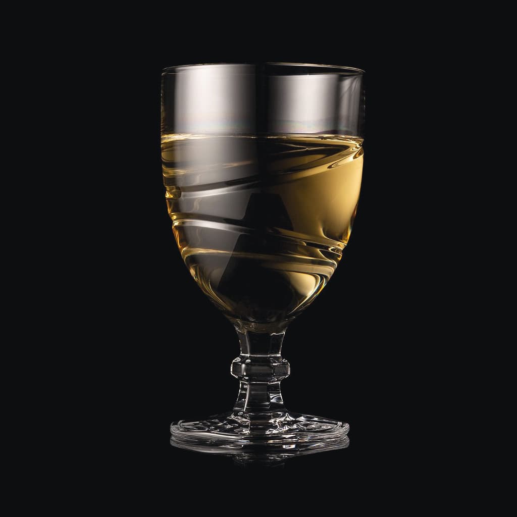 SHTOX Orbit wine glass with white wine, on black